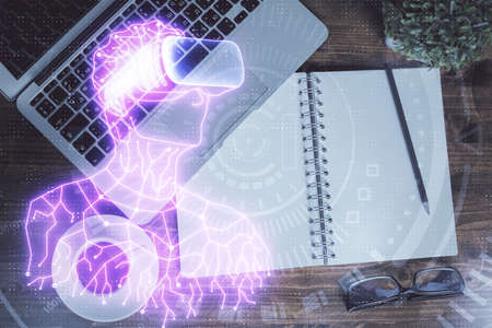 AR hologram drawings over computer on the desktop background. Top view. Multi exposure. Concept of...