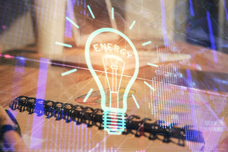 Double exposure of bulb drawing and desk with open notebook background. Concept of ideaの写真素材