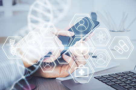 Double exposure of man's hands holding and using a phone and DNA drawing. Medical education concept.
