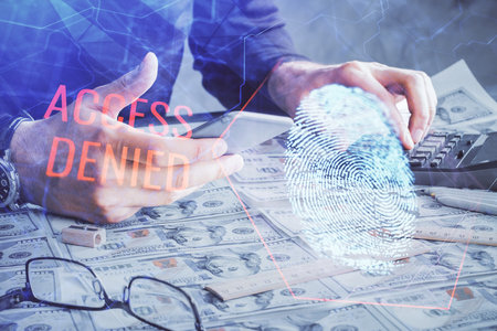 Double exposure of man's hands holding and using a digital device and fingerprint hologram drawing. Security concept.の写真素材