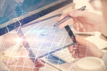Multi exposure of man's hands holding and using a digital device and map drawing. International...