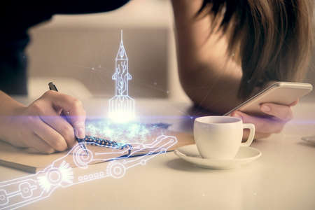 Double exposure of creative hologram and woman holding and using a mobile device. Start up concept.