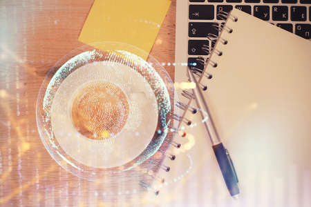 Double exposure of map hologram drawing over study table background with computer. Concept of international network. Top view.の写真素材