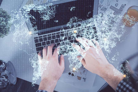 Double exposure of man's hands typing over computer keyboard and social network theme hologram drawing. Top view. People connection web concept.の写真素材