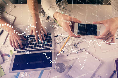 Double exposure of man and woman working together and data theme hologram drawing. Computer...