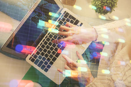 Double exposure of woman hands working on computer and data theme hologram drawing. Top View. Technology concept.の写真素材