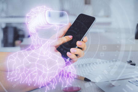 Double exposure of man's hands holding and using a digital device and AR glasses drawing. Virtual reality concept.の写真素材