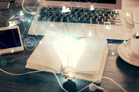 Double exposure of bulb drawing and desk with open notebook background. Concept of ideaの写真素材