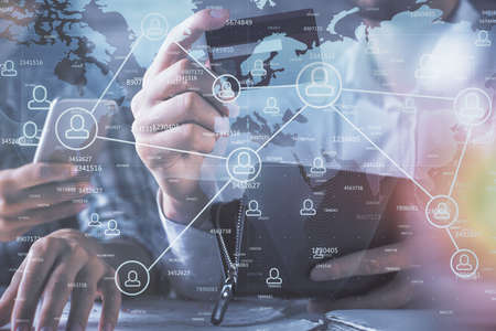 Double exposure of man and woman on-line shopping holding a credit card and social network theme...