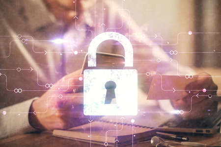 Multi exposure of man's hands holding and using a digital device and lock drawing. Security concept.