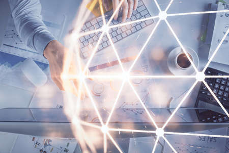 Double exposure of man's hands typing over computer keyboard and social network theme hologram drawing. Top view. People connection web concept.の写真素材
