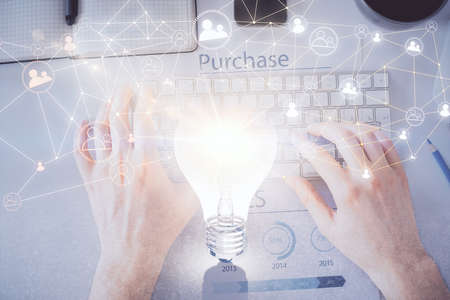 Double exposure of man's hands typing over computer keyboard and social network theme hologram...