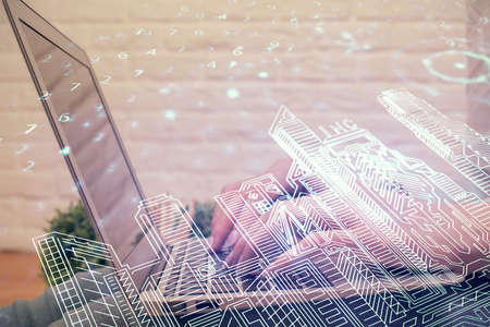 Double exposure of woman hands typing on computer and buildings drawing. Smart-city concept.の写真素材