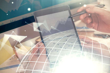 Multi exposure of man's hands holding and using a digital device and map drawing. International...