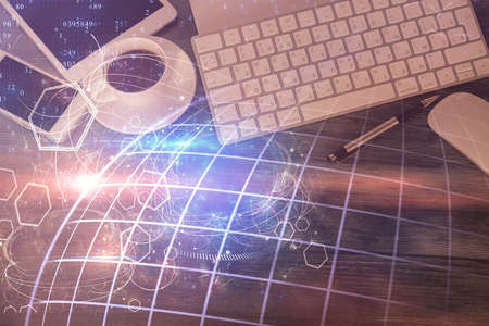 Double exposure of map hologram drawing over desktop. Top view. International connection concept.