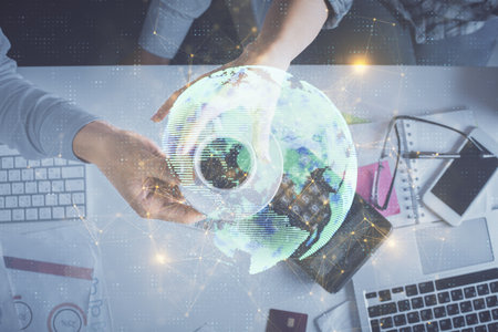 Double exposure of man and woman working together and social network theme hologram drawing. Computer background. connecting concept. Top View.の写真素材