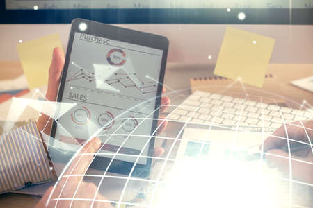 Multi exposure of man's hands holding and using a digital device and map drawing. International business concept.の写真素材
