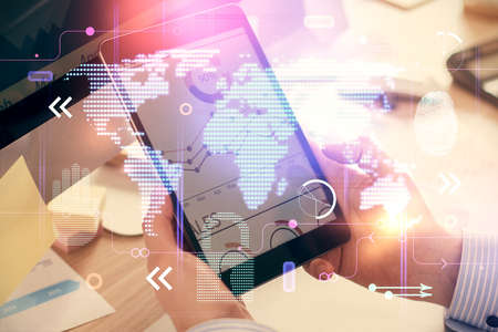 Multi exposure of man's hands holding and using a digital device and map drawing. International...