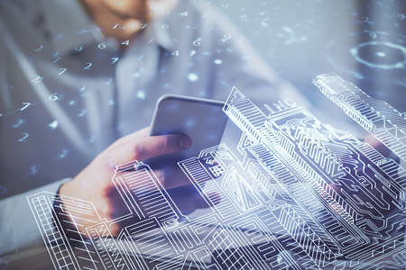 Double exposure of man's hands holding and using a digital device and city drawing.