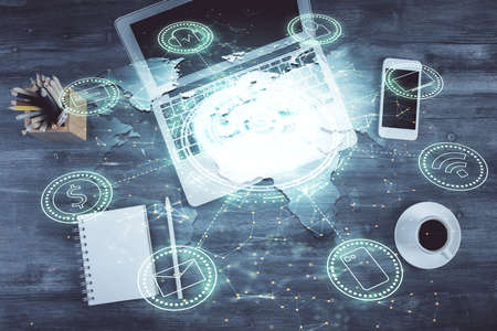 Social network hologram drawings over computer on the desktop background. Top view. Multi exposure....