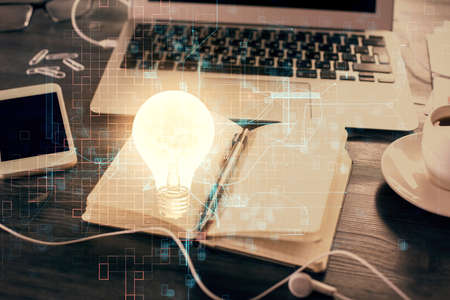 Double exposure of bulb drawing and desk with open notebook background. Concept of ideaの写真素材