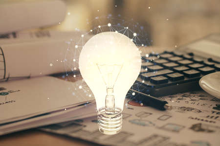 Double exposure of bulb drawing and desk with open notebook background. Concept of ideaの写真素材