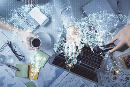 Double exposure of man and woman working together and social network theme hologram drawing. Computer background. connecting concept. Top View.の写真素材