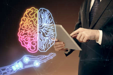 Double exposure of man's hand holding and using a digital device and brain hologram drawing. Data...