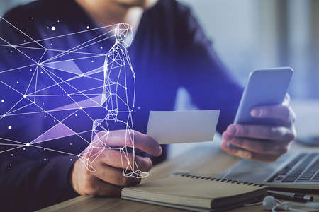 Double exposure of man's hands holding and using a mobile device and creative hologram drawing.