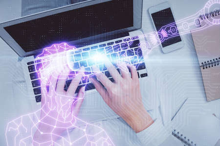 Double exposure of woman hands working on computer and man in ar glasses hologram drawing. Top View. Virtual reality concept.の写真素材