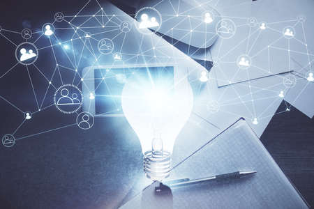 Double exposure of bulb drawing over table with phone. Top view. Concept of idea.の写真素材