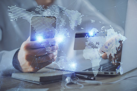 Double exposure of man hands holding a credit card and social network theme drawing. Digital finance and E-commerce concept.の写真素材