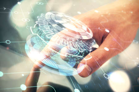 Multi exposure of man's hand holding and using a digital device and data theme drawing. Innovation concept.の写真素材