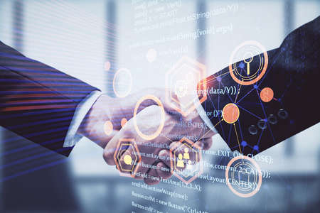 Double exposure of data theme hologram and handshake of two men. Partnership in IT industry concept.