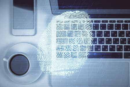 Finger print over computer on the desktop background. Top view. Double exposure. Concept of securitization.の写真素材