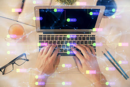 Multi exposure of man's hands typing over computer keyboard and data theme hologram drawing. Top...