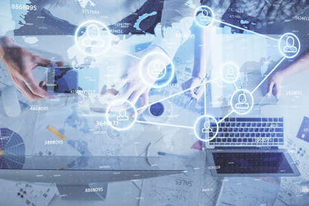 Double exposure of man and woman working together and social network theme hologram drawing. Computer background. connecting concept. Top View.の写真素材