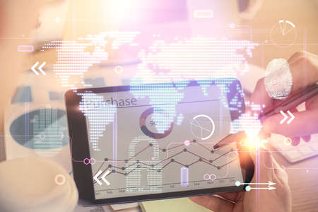 Multi exposure of man's hands holding and using a digital device and map drawing. International...