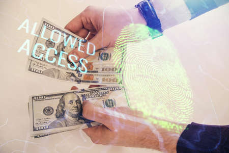 Multi exposure of fingerprint drawing hologram and USA dollars bills and man hands. security concept.の写真素材