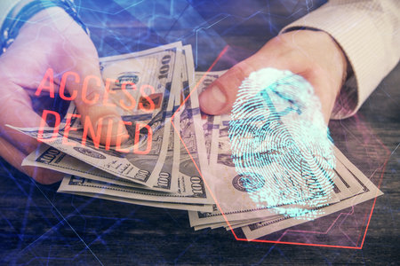 Multi exposure of fingerprint drawing hologram and USA dollars bills and man hands. security concept.の写真素材