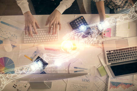 Double exposure of man and woman working together and data theme hologram drawing. Computer...