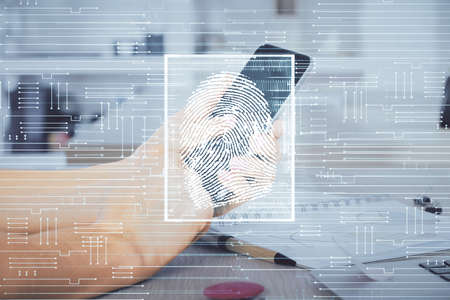 Double exposure of man's hands holding and using a digital device and fingerprint hologram drawing. Security concept.の写真素材