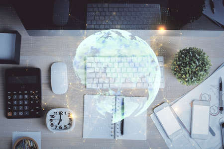 Social network hologram drawings over computer on the desktop background. Top view. Multi exposure. Concept of people connection.の写真素材