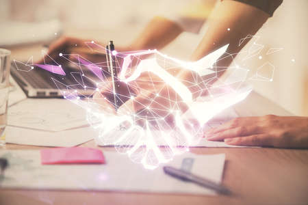 Double exposure of woman hands typing on computer and handshake drawing. Partnership concept.の写真素材