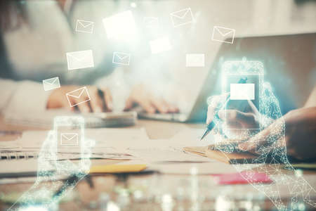 Double exposure of woman hands typing on computer and flying envelop drawing. E-Mail concept.の写真素材