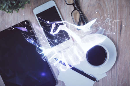 Multi exposure of handshake drawing over table with phone. Top view. Concept of partnership.の写真素材
