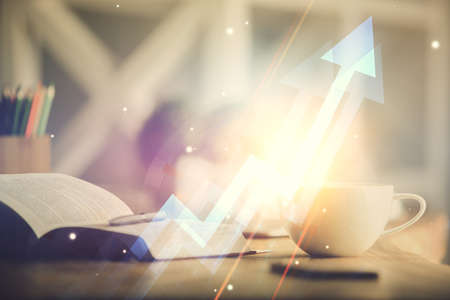 Double exposure of arrows drawing and desktop with coffee and items on table background. Concept of...