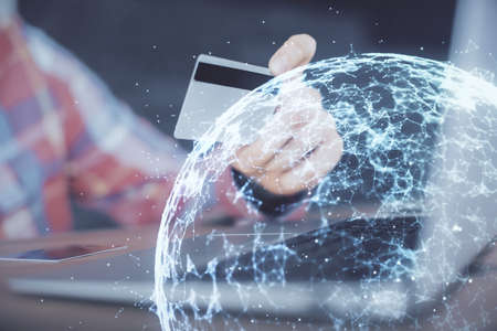 Double exposure of man hands holding a credit card and social network theme drawing. Digital finance...