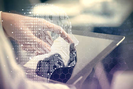 Double exposure of man's hand holding and using a digital device and brain hologram drawing. Data...