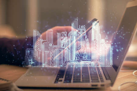 Double exposure of man's hands holding and using a digital device and city drawing.の写真素材